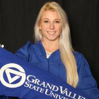 woman with grand valley flag at GradFest